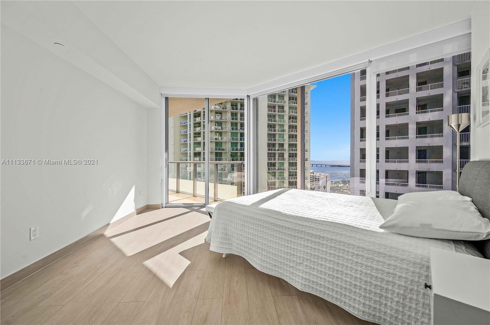 1300 Brickell Bay Drive, Unit 1603 Miami, FL 33131 - Photo 15 of 32 a bedroom with a bed and a large window