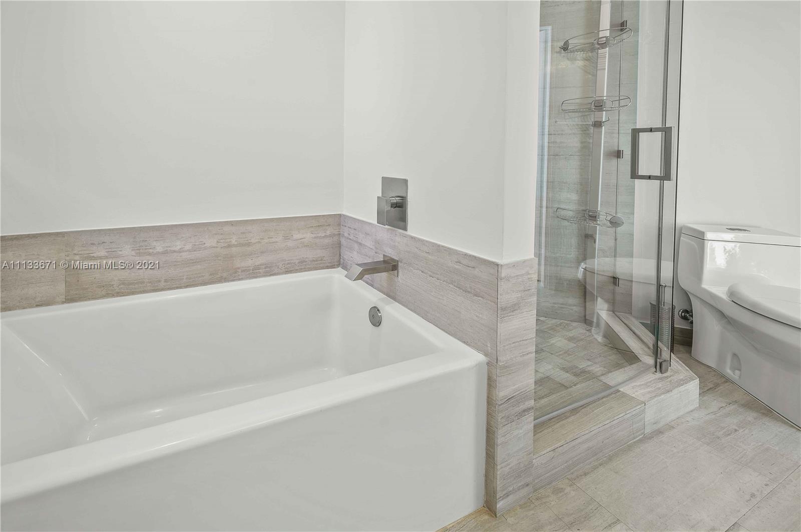1300 Brickell Bay Drive, Unit 1603 Miami, FL 33131 - Photo 19 of 32 a bath tub sitting next to a shower
