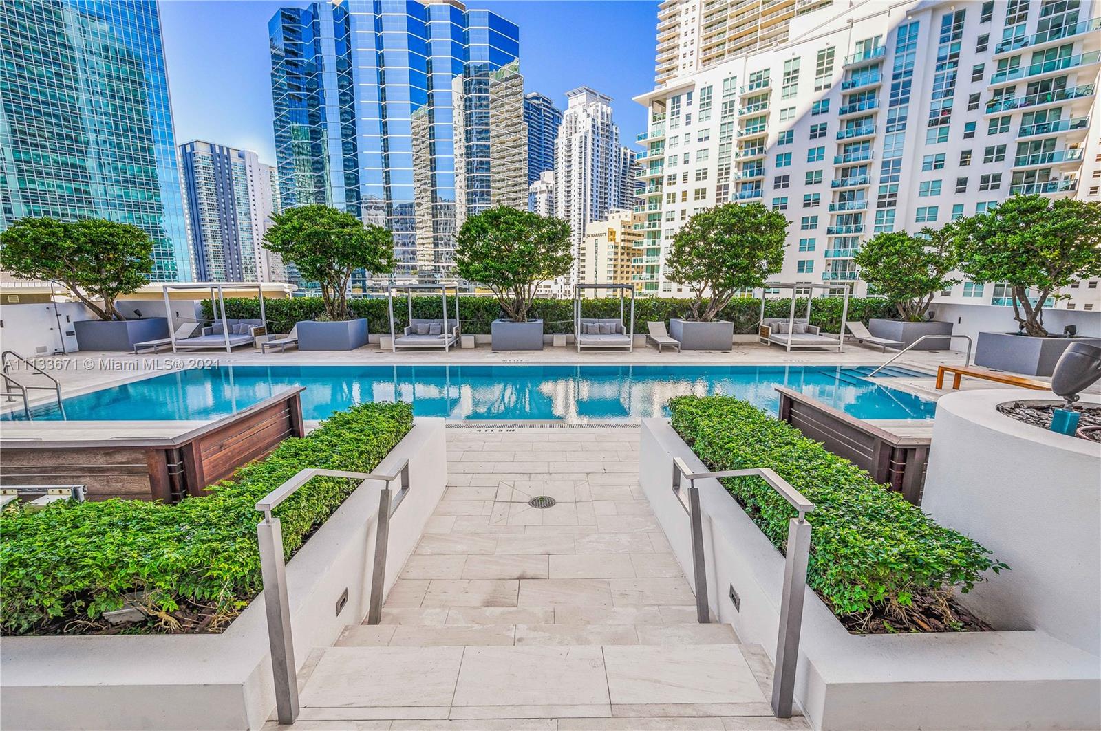 1300 Brickell Bay Drive, Unit 1603 Miami, FL 33131 - Photo 29 of 32 a view of a swimming pool with outdoor seating