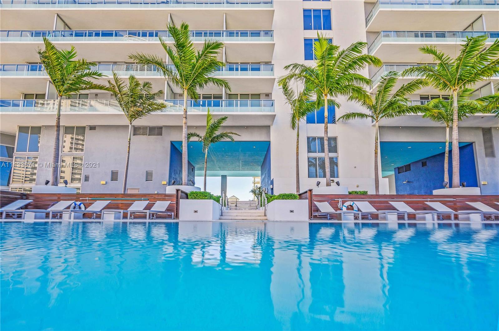 1300 Brickell Bay Drive, Unit 1603 Miami, FL 33131 - Photo 31 of 32 a swimming pool view with a outdoor seating