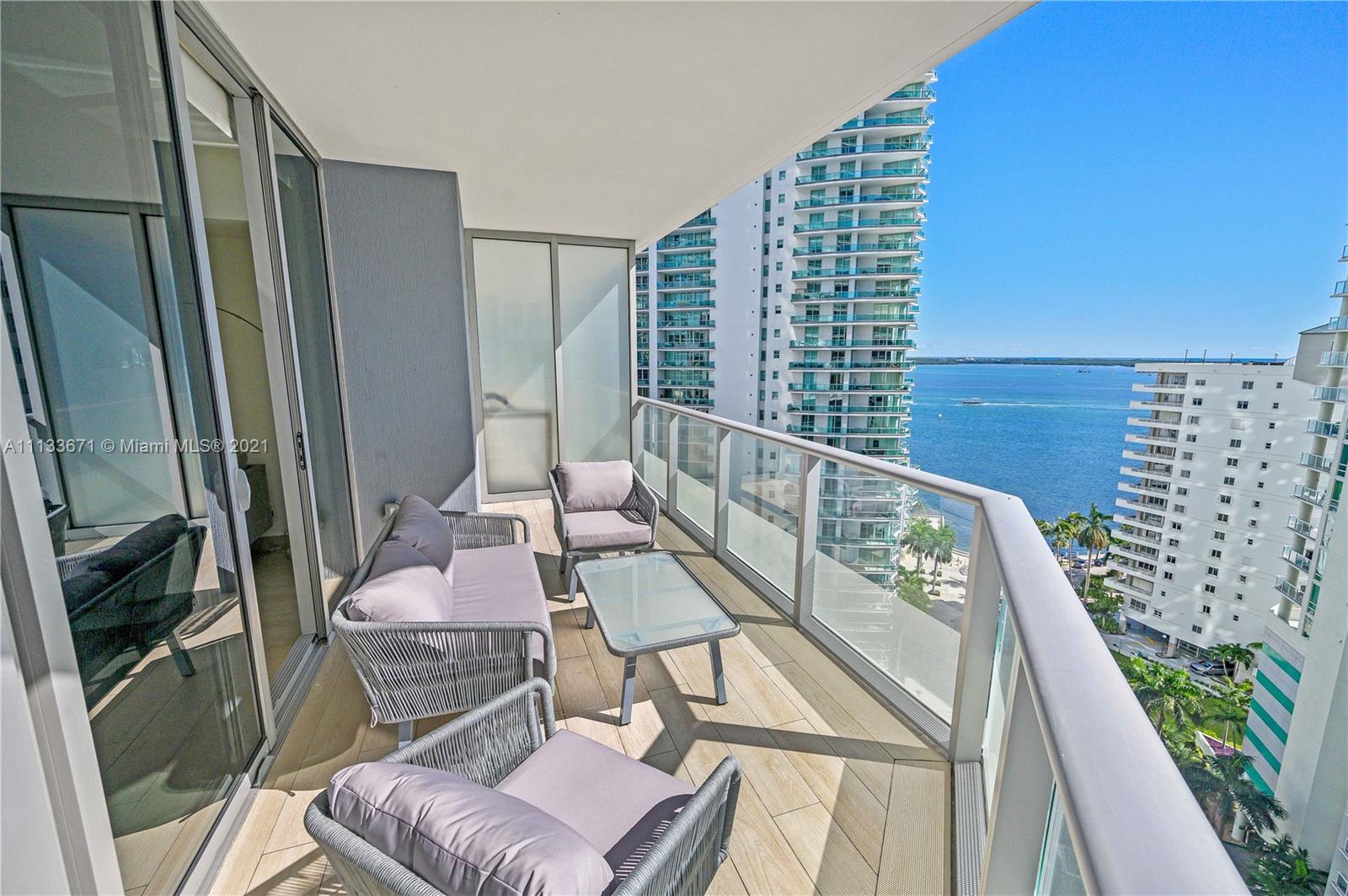 1300 Brickell Bay Drive, Unit 1603 Miami, FL 33131 - Photo 6 of 32 a balcony with furniture and a potted plant