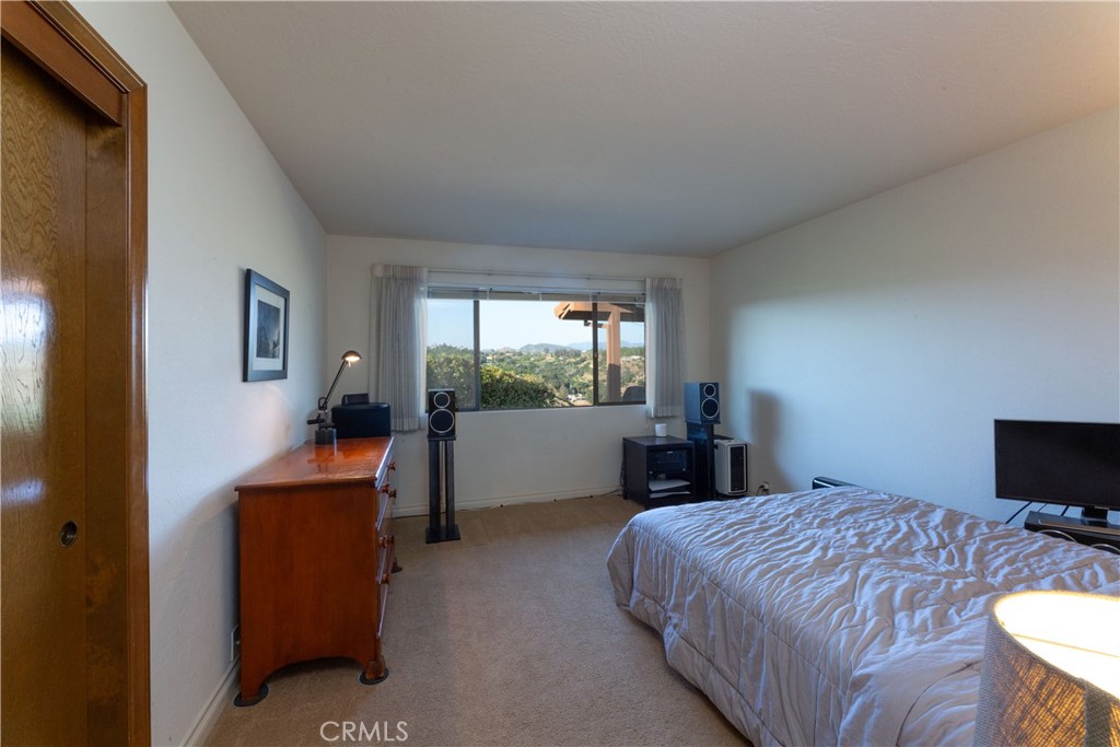 2509 Valerie Drive Fallbrook, CA 92028 - Photo 39 of 70 a bedroom with a bed and a flat tv screen on the dresser