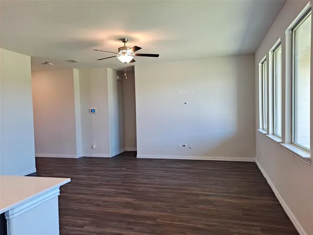 a view of a room with wooden floor and chandelier