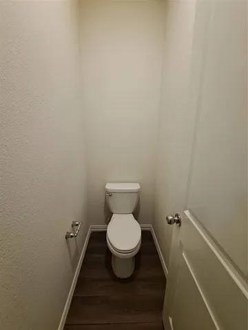 a white toilet sitting in a bathroom