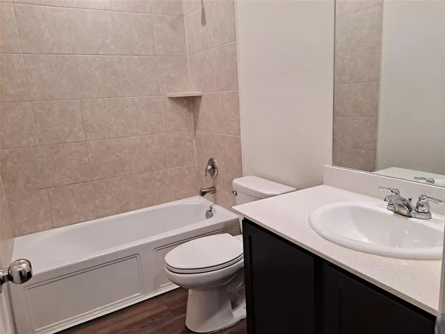 a bathroom with a sink a toilet and bathtub