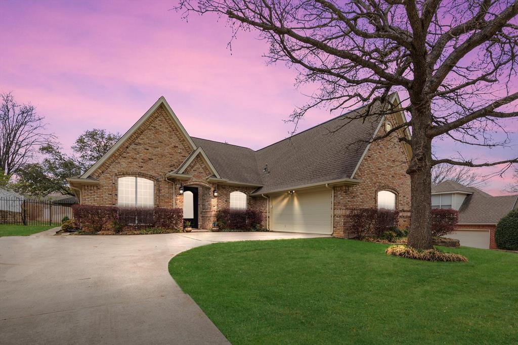 a front view of a house with a garden and yard