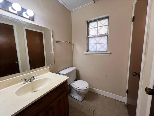 a bathroom with a double vanity sink toilet and a mirror