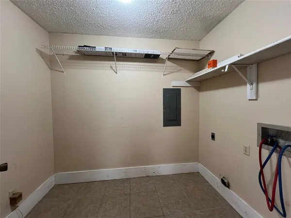 a view of storage and utility room with racks on the wall