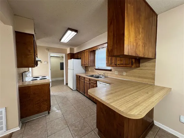 a kitchen with stainless steel appliances a stove sink and microwave