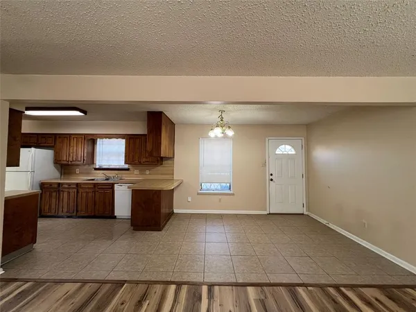 a large white kitchen with a sink a stove top oven and cabinets