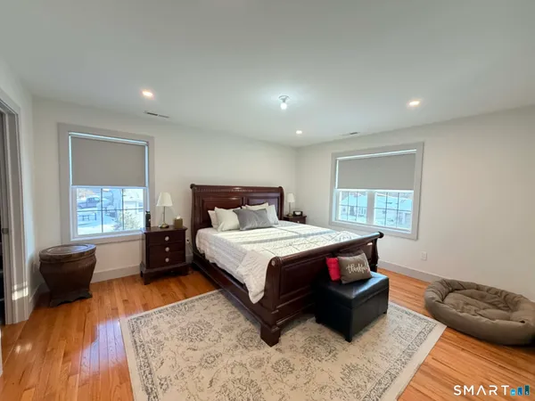 a spacious bedroom with a bed and a couch