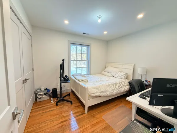 a bedroom with two beds and a window