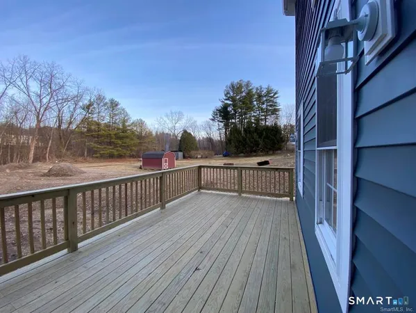a view of balcony with wooden floor and fence