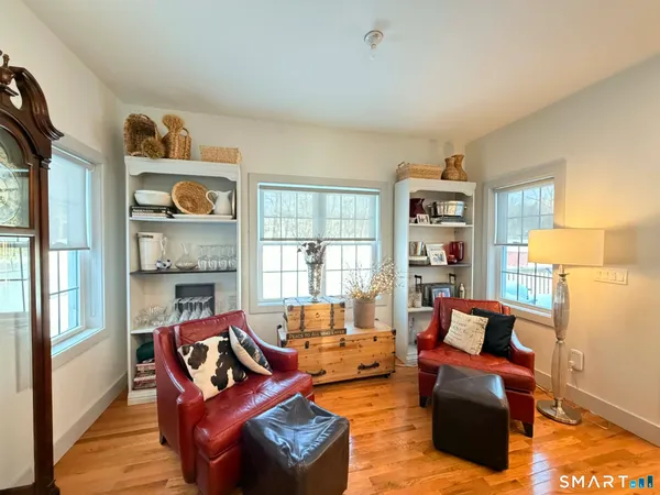 a living room with furniture and a floor to ceiling window