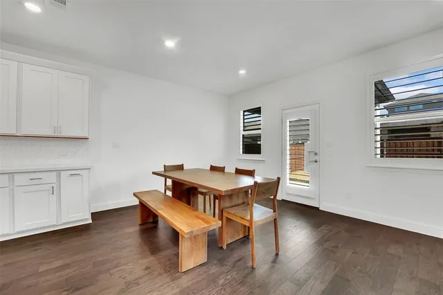 a room with furniture pool table and wooden floor