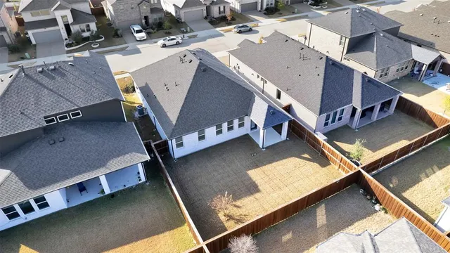 an aerial view of residential houses with yard