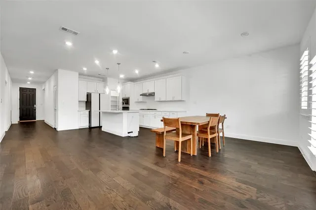 a view of a dining room with furniture and wooden floor