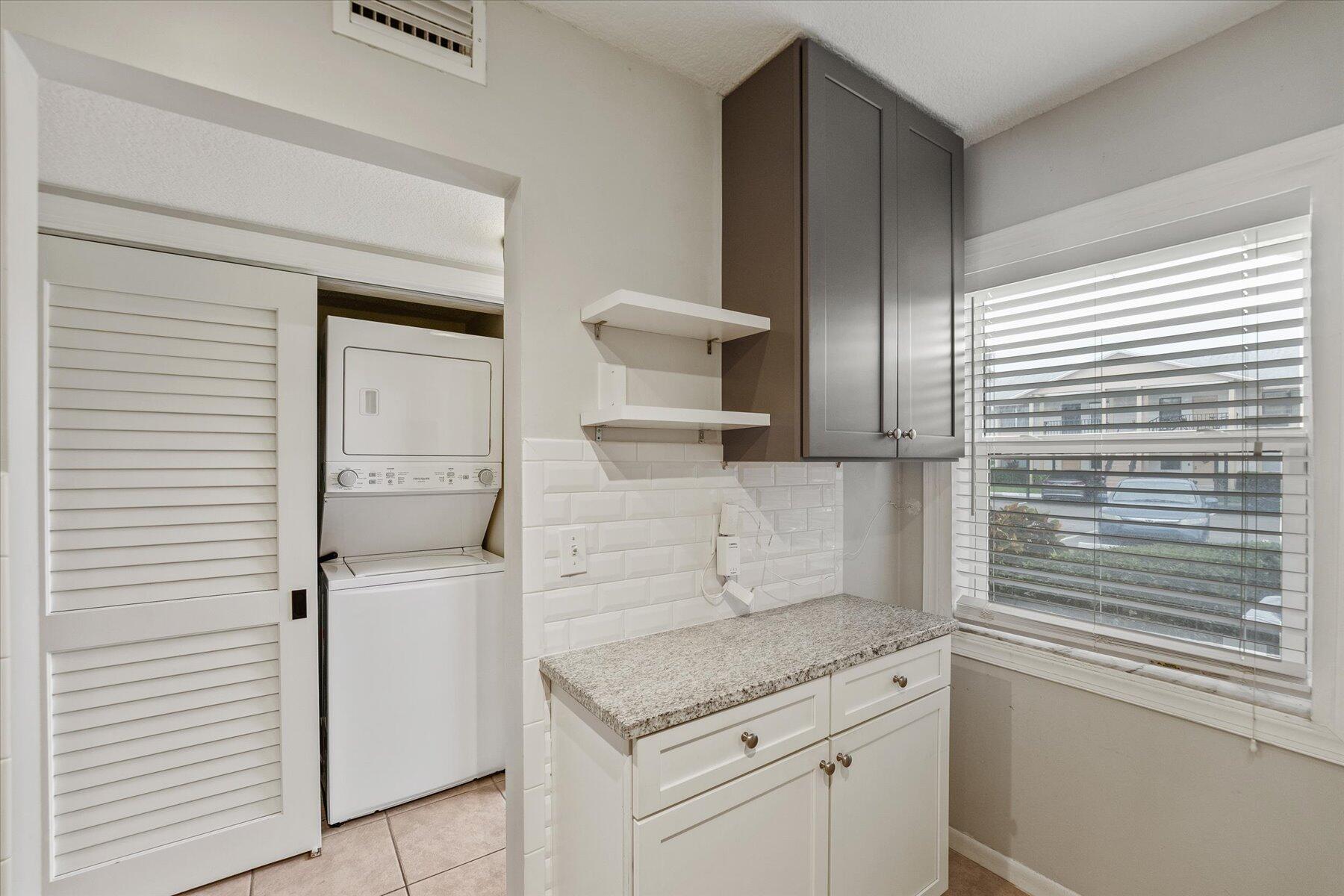 3151 Southeast Aster Lane, Unit 1302 Stuart, FL 34994 - Photo 11 of 23 a kitchen with a sink and cabinets