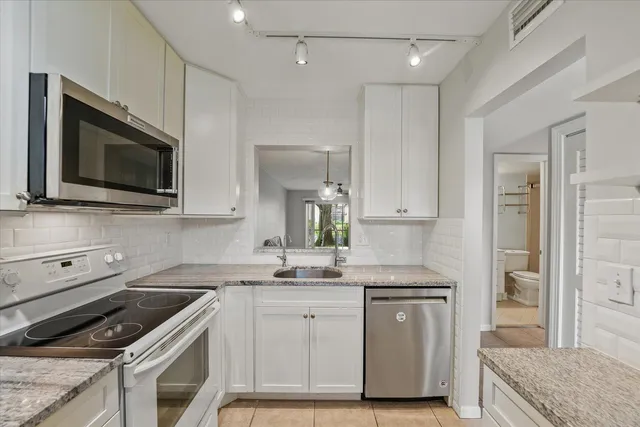 a kitchen with a sink stove and microwave