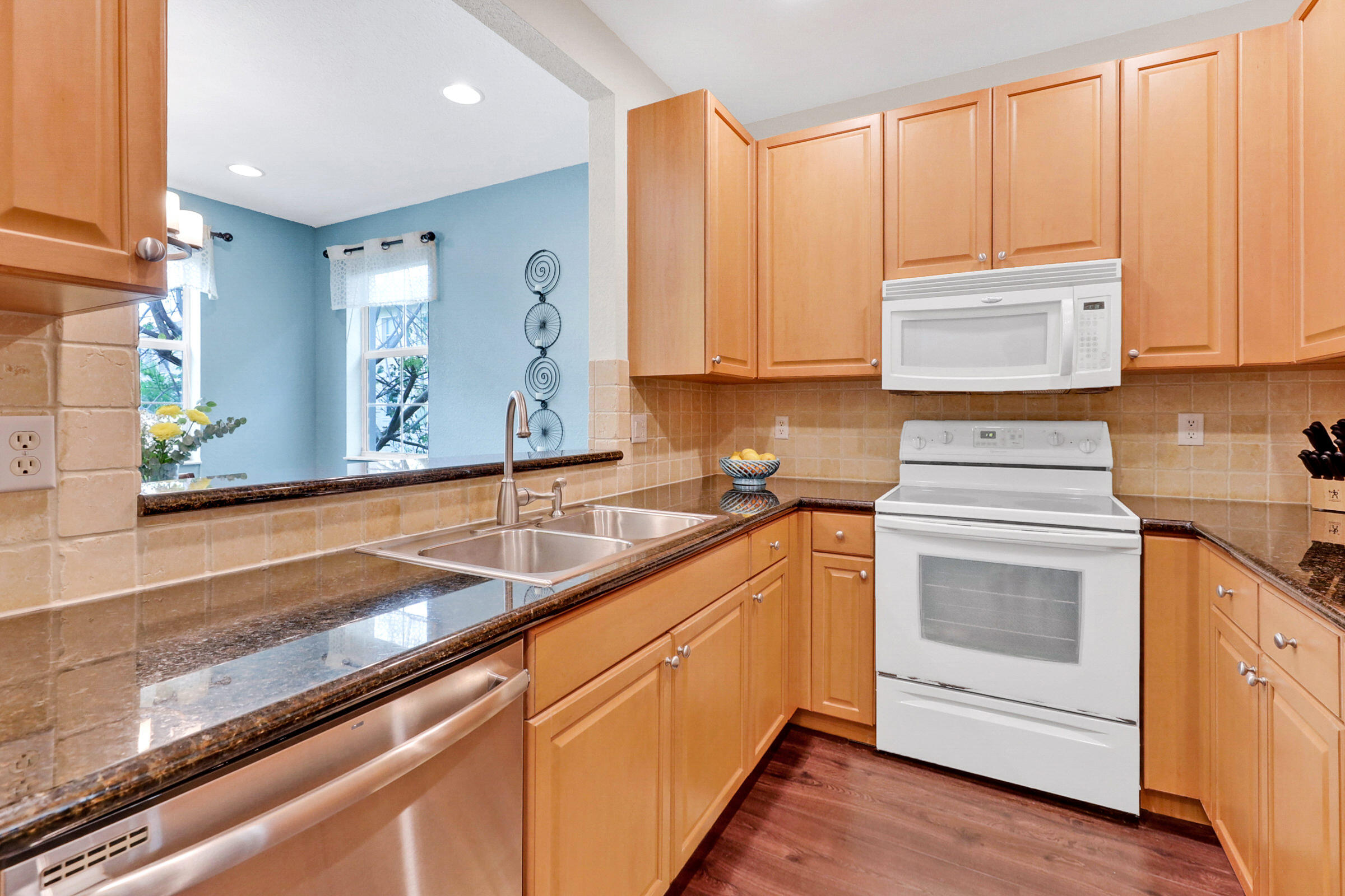 1582 Grande Cull Way Jupiter, FL 33458 - Photo 15 of 75 a kitchen with granite countertop a sink a stove and cabinets
