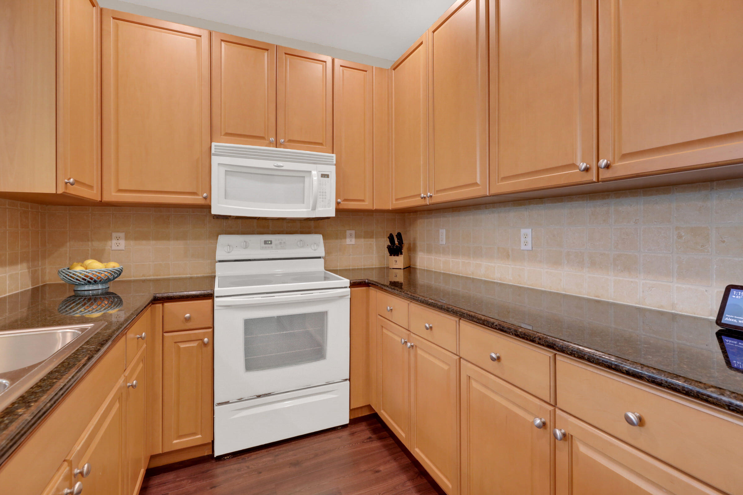 1582 Grande Cull Way Jupiter, FL 33458 - Photo 16 of 75 a kitchen with granite countertop cabinets and white appliances