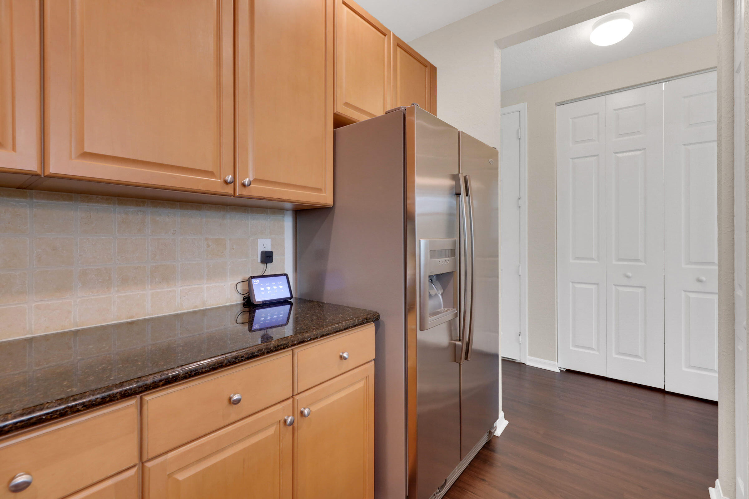 1582 Grande Cull Way Jupiter, FL 33458 - Photo 17 of 75 a kitchen with stainless steel appliances granite countertop a refrigerator and a sink