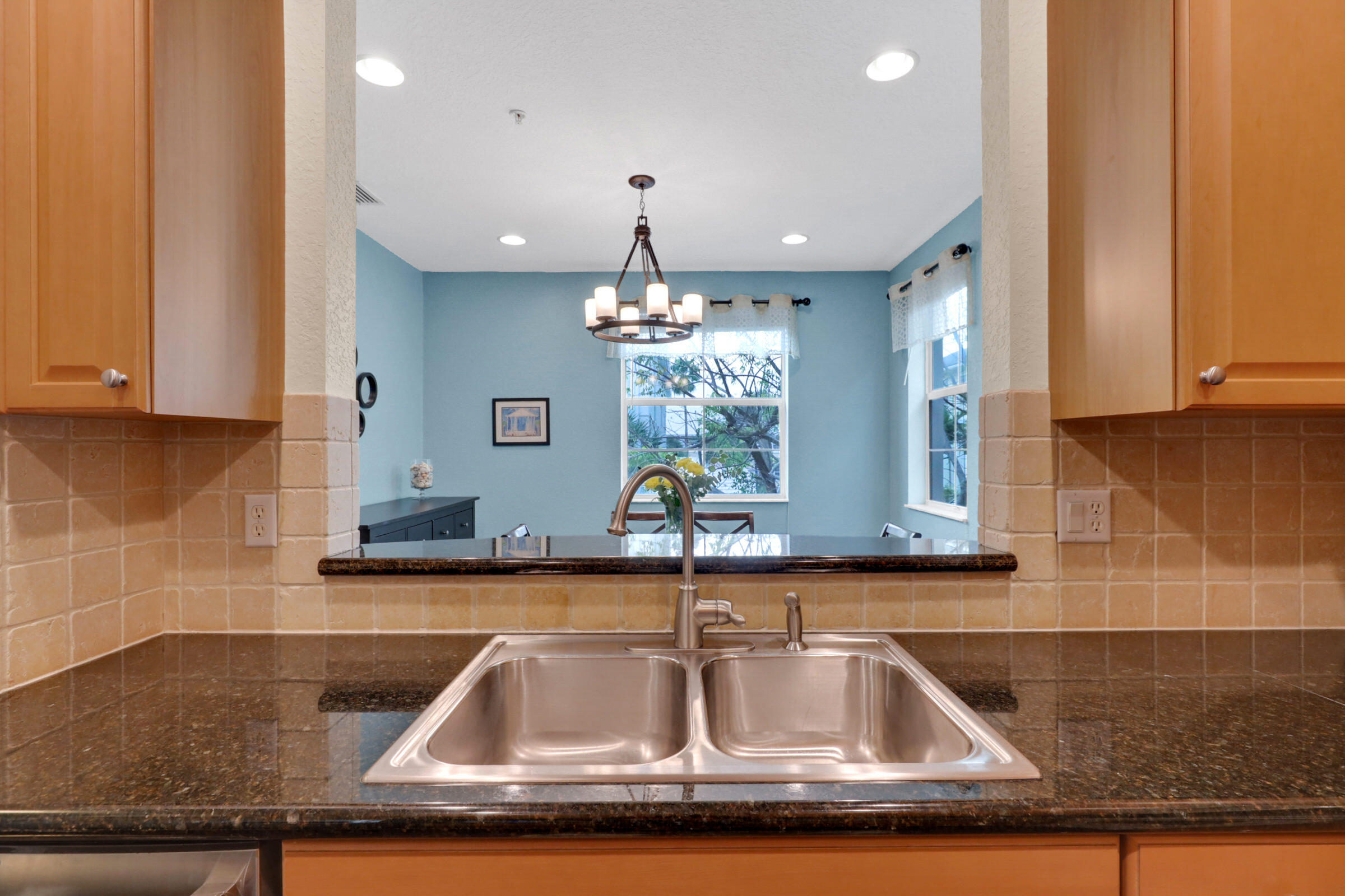 1582 Grande Cull Way Jupiter, FL 33458 - Photo 19 of 75 a kitchen with kitchen island granite countertop a sink a counter top space and cabinets