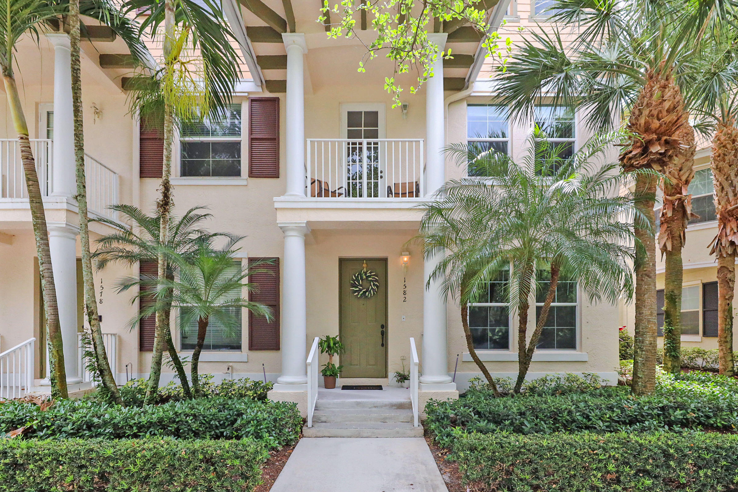 1582 Grande Cull Way Jupiter, FL 33458 - Photo 2 of 75 a front view of a house with a yard