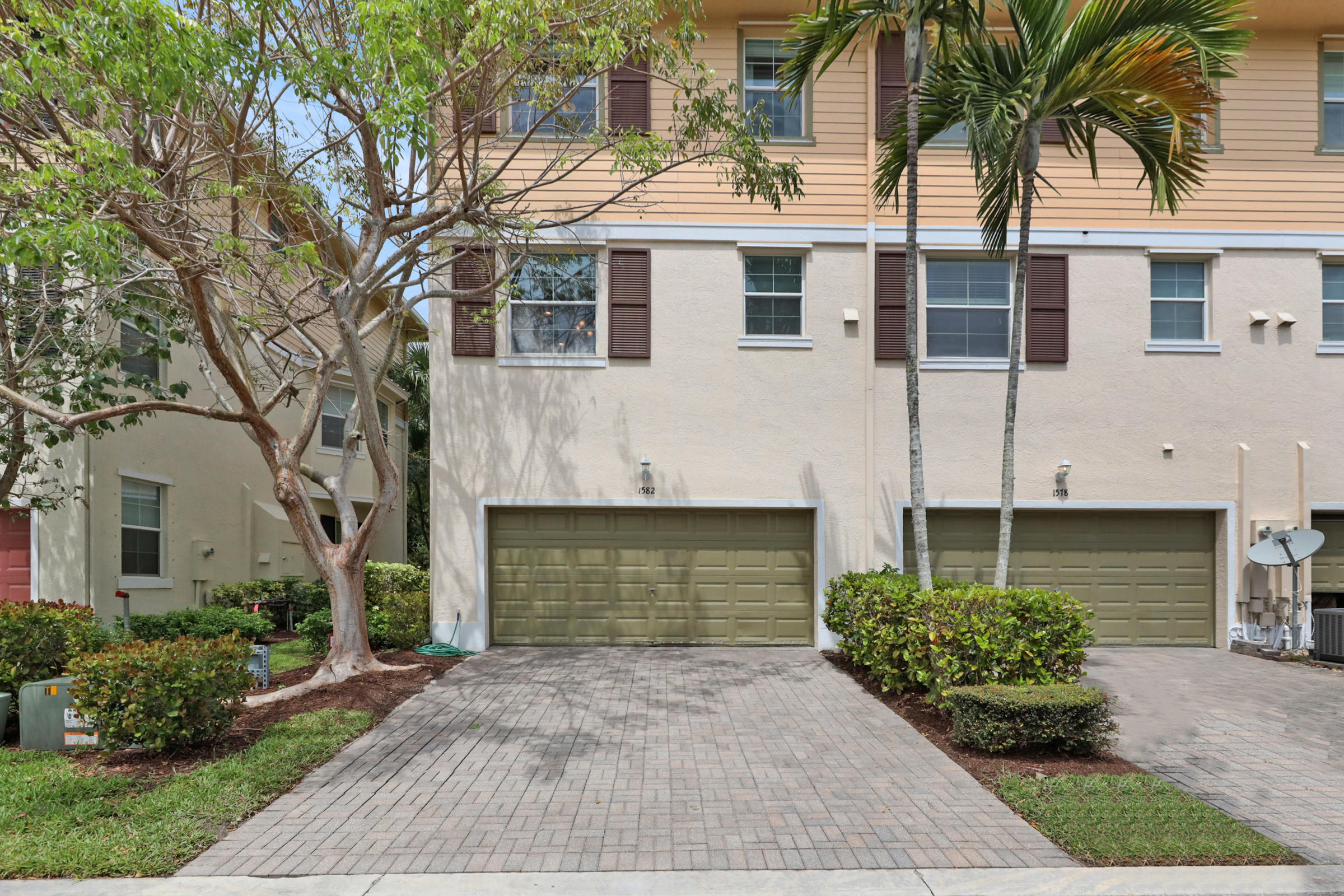 1582 Grande Cull Way Jupiter, FL 33458 - Photo 37 of 75 a front view of a house with a yard and garage