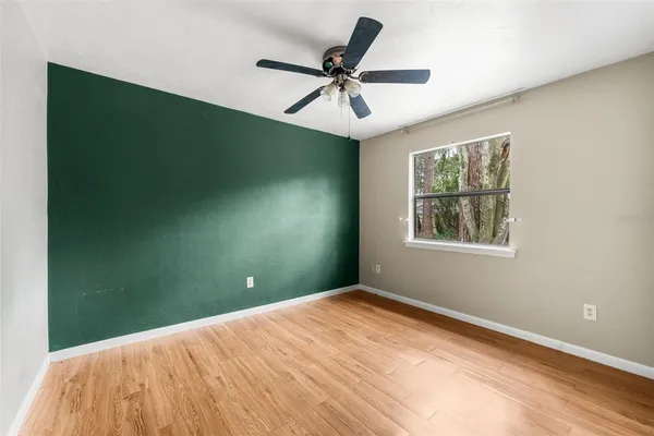 a view of a room with a ceiling fan and a window