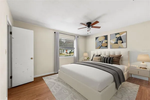 a bedroom with a large bed and a chandelier