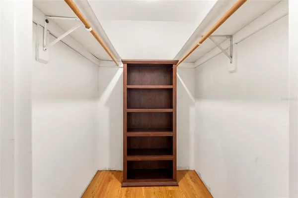 a view of walk in closet with empty racks