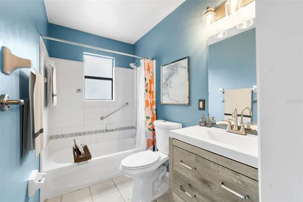 a bathroom with a sink toilet vanity and shower