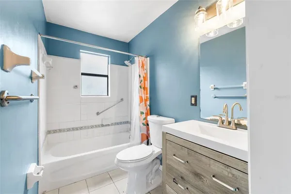a bathroom with a sink toilet vanity and tub