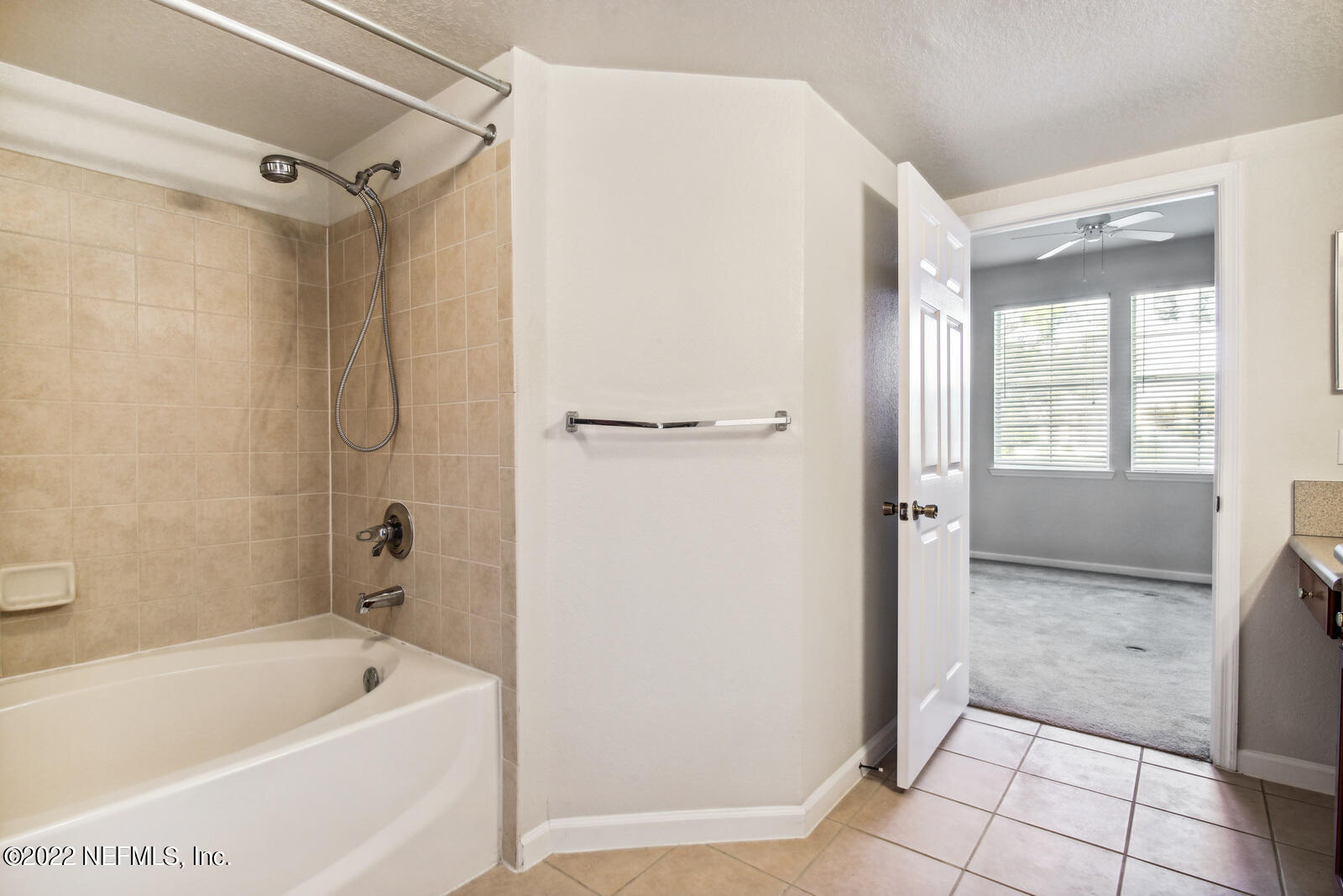 8550 Touchton Road, Unit 1438 Jacksonville, FL 32216 - Photo 15 of 37 a bathroom with a tub a shower and view