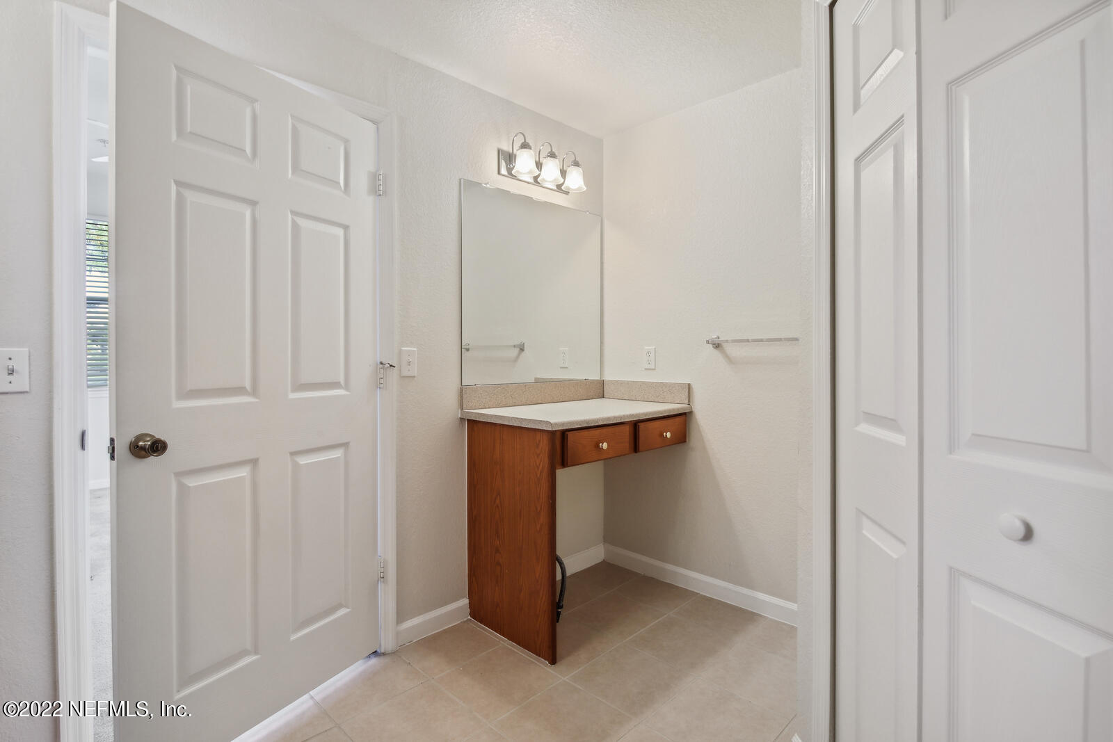 8550 Touchton Road, Unit 1438 Jacksonville, FL 32216 - Photo 19 of 37 a bathroom with a sink and a mirror