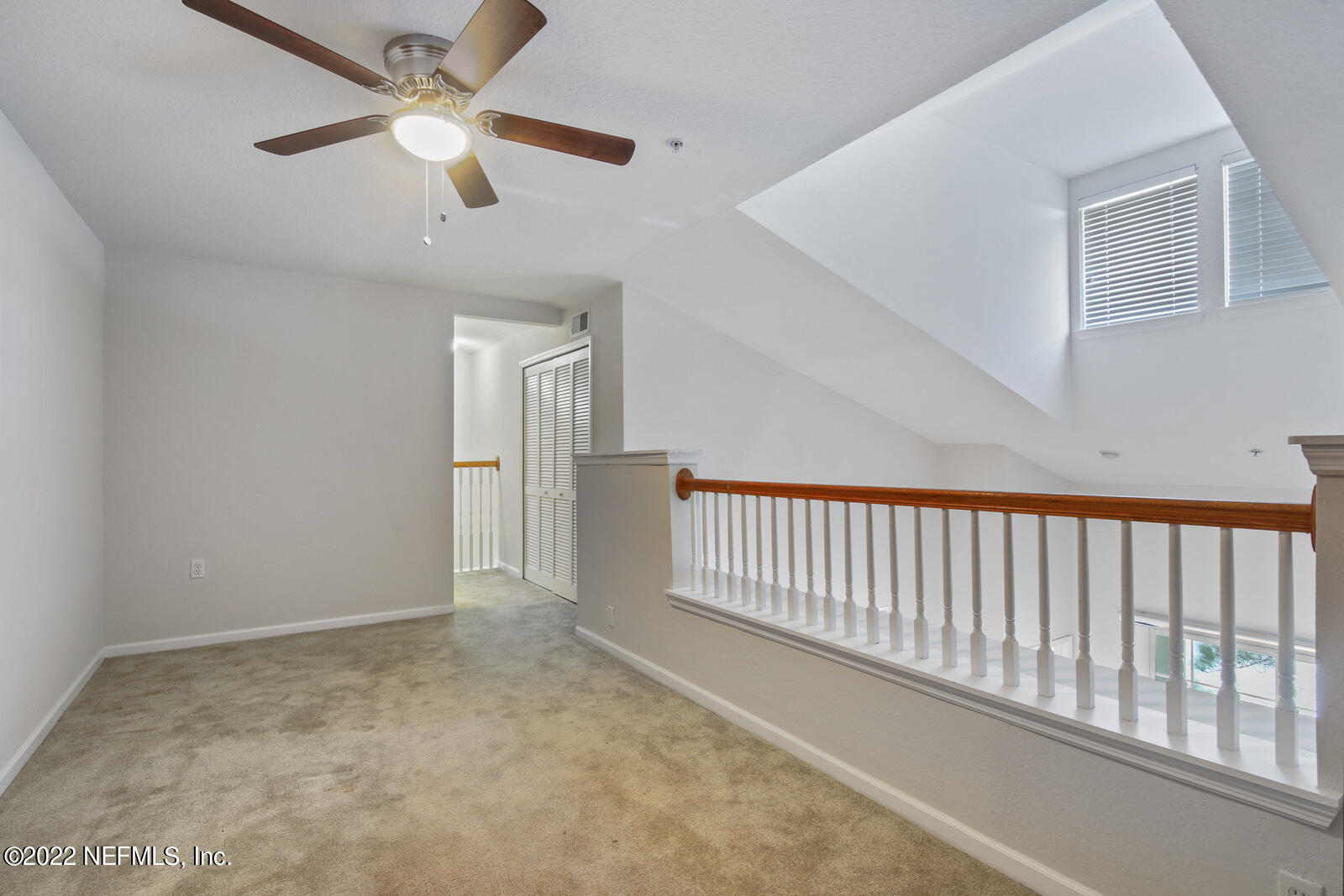 8550 Touchton Road, Unit 1438 Jacksonville, FL 32216 - Photo 21 of 37 an empty room with ceiling fan and windows