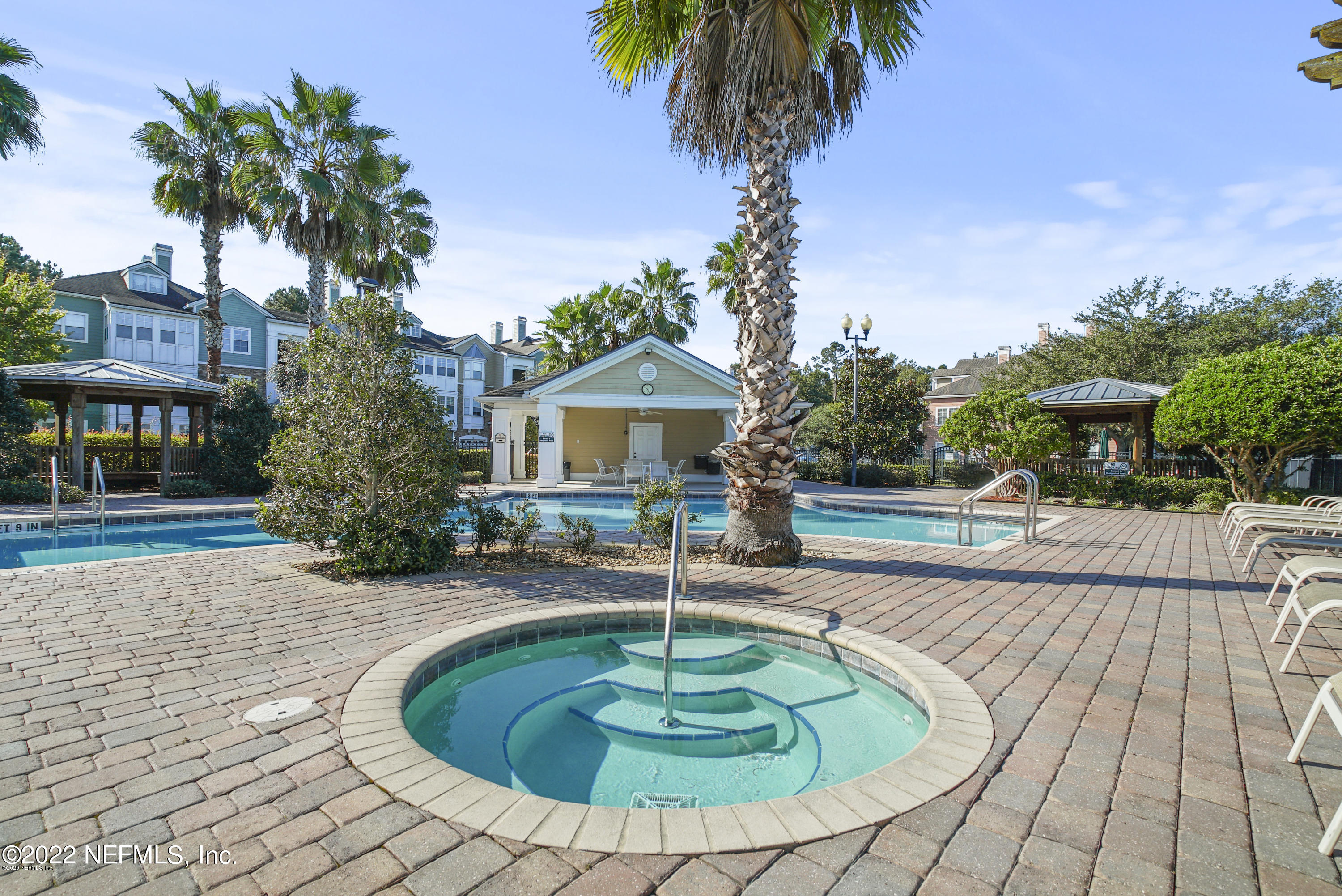 8550 Touchton Road, Unit 1438 Jacksonville, FL 32216 - Photo 36 of 37 a swimming pool with outdoor seating yard and palm trees