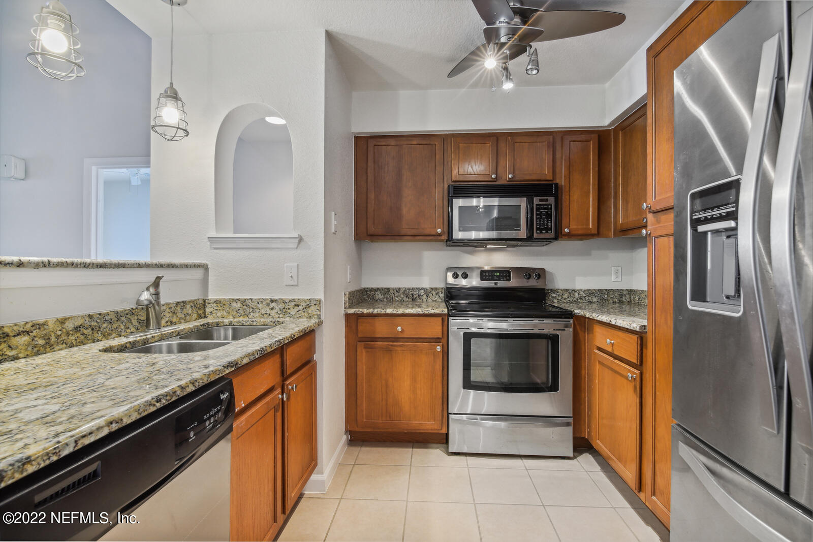 8550 Touchton Road, Unit 1438 Jacksonville, FL 32216 - Photo 7 of 37 a kitchen with stainless steel appliances granite countertop a sink stove and refrigerator
