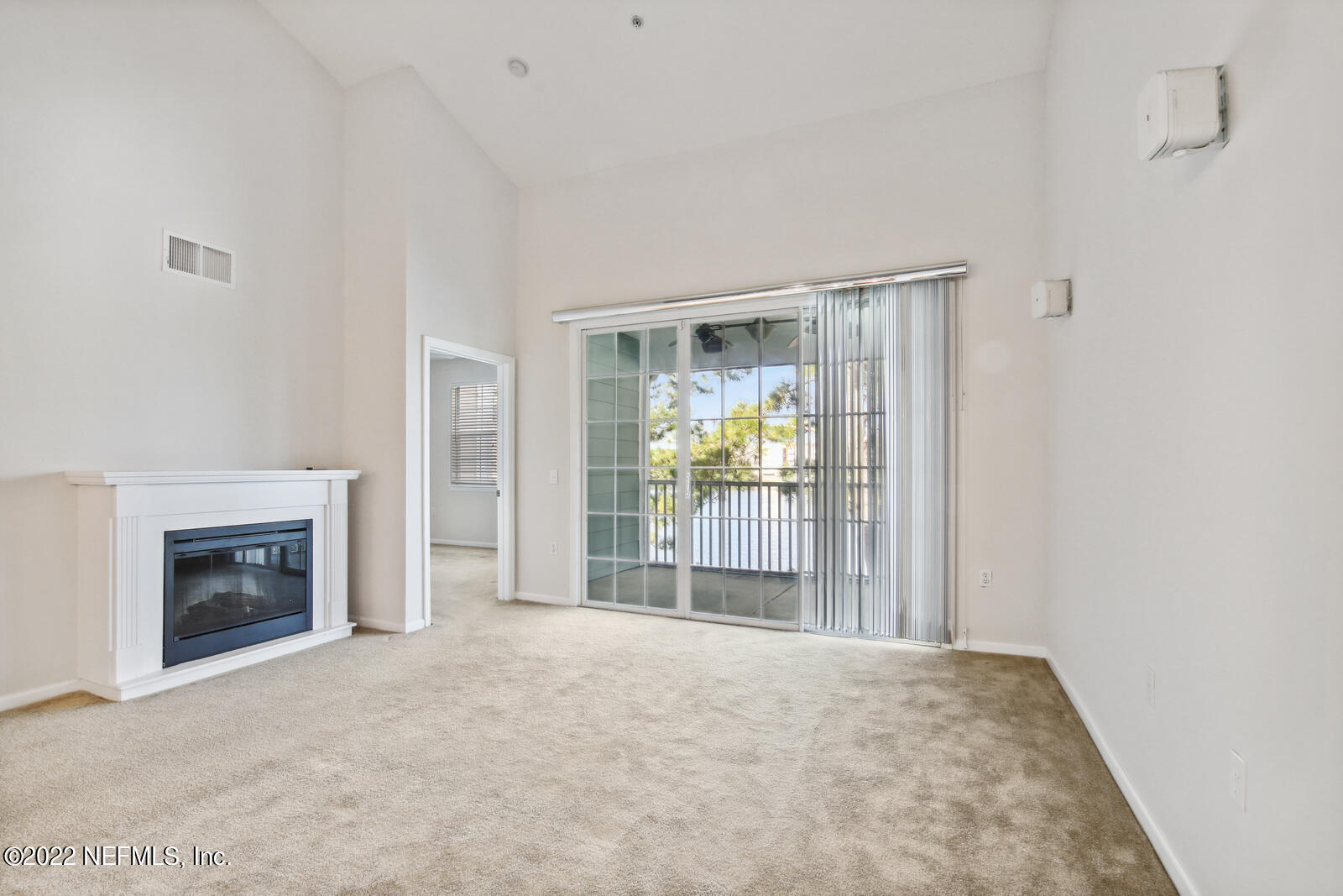 8550 Touchton Road, Unit 1438 Jacksonville, FL 32216 - Photo 9 of 37 a view of an empty room with a fireplace and a window