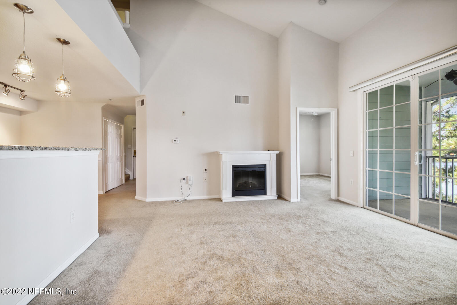 8550 Touchton Road, Unit 1438 Jacksonville, FL 32216 - Photo 10 of 37 a view of an empty room with a fireplace and a window