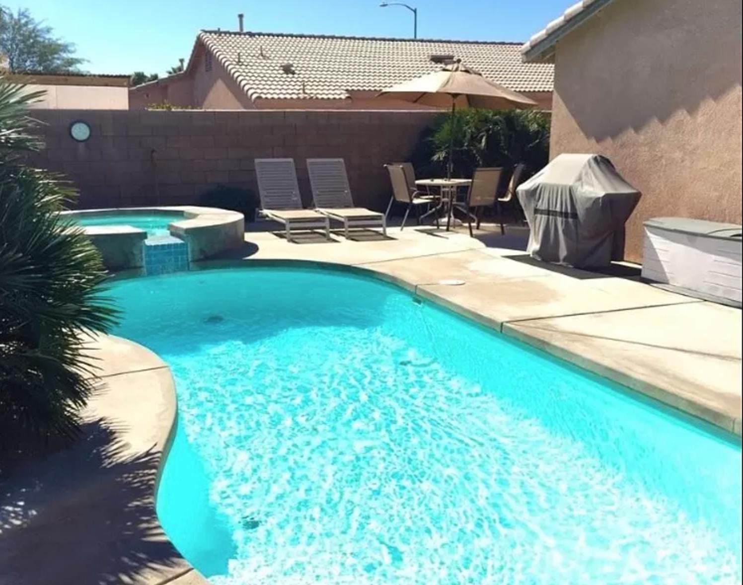 a backyard of a house with table and chairs