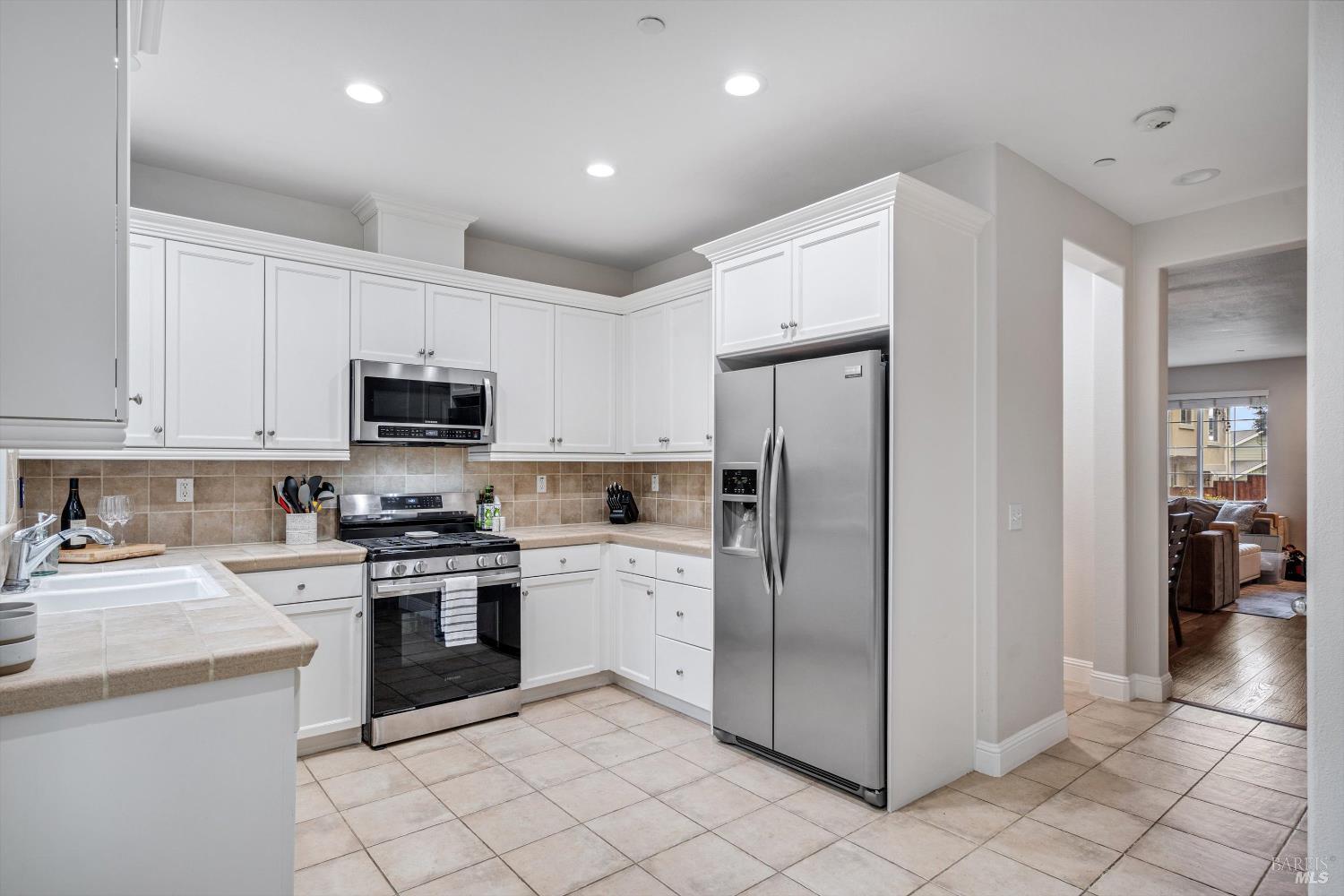 2084 Cooper Drive Santa Rosa, CA 95404 - Photo 11 of 39 Kitchen showing entrance to the storage and half bath, as well as the peek through into the dining and living room.
