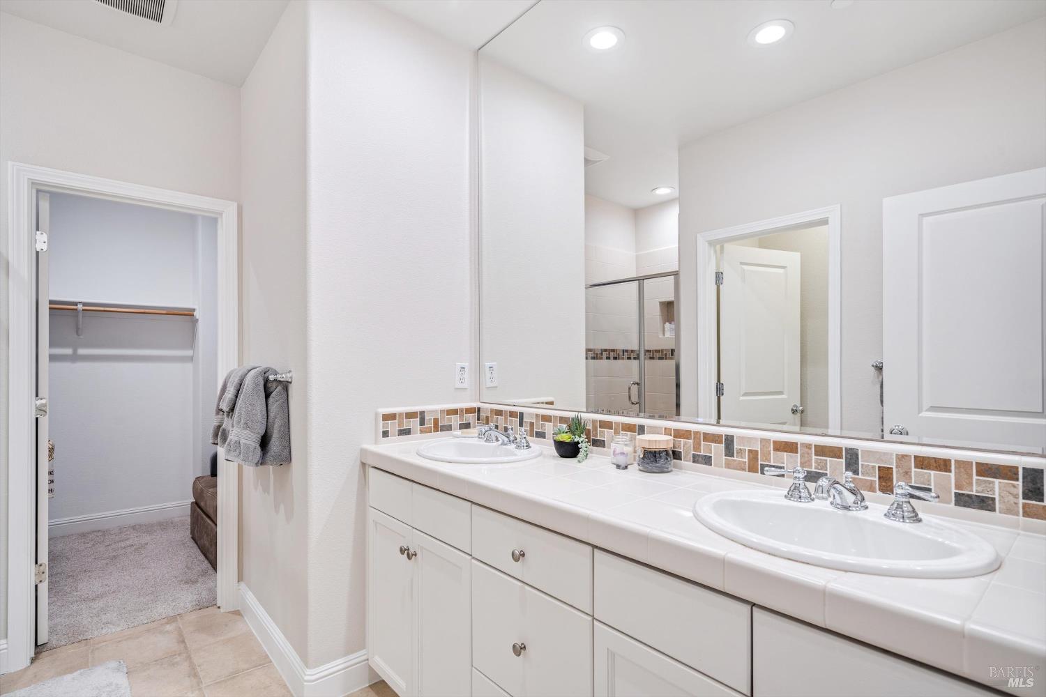 2084 Cooper Drive Santa Rosa, CA 95404 - Photo 14 of 37 Primary bath with dual sinks, separate water closet for toilet, shower, and through to a walk in closet that was used as an office.