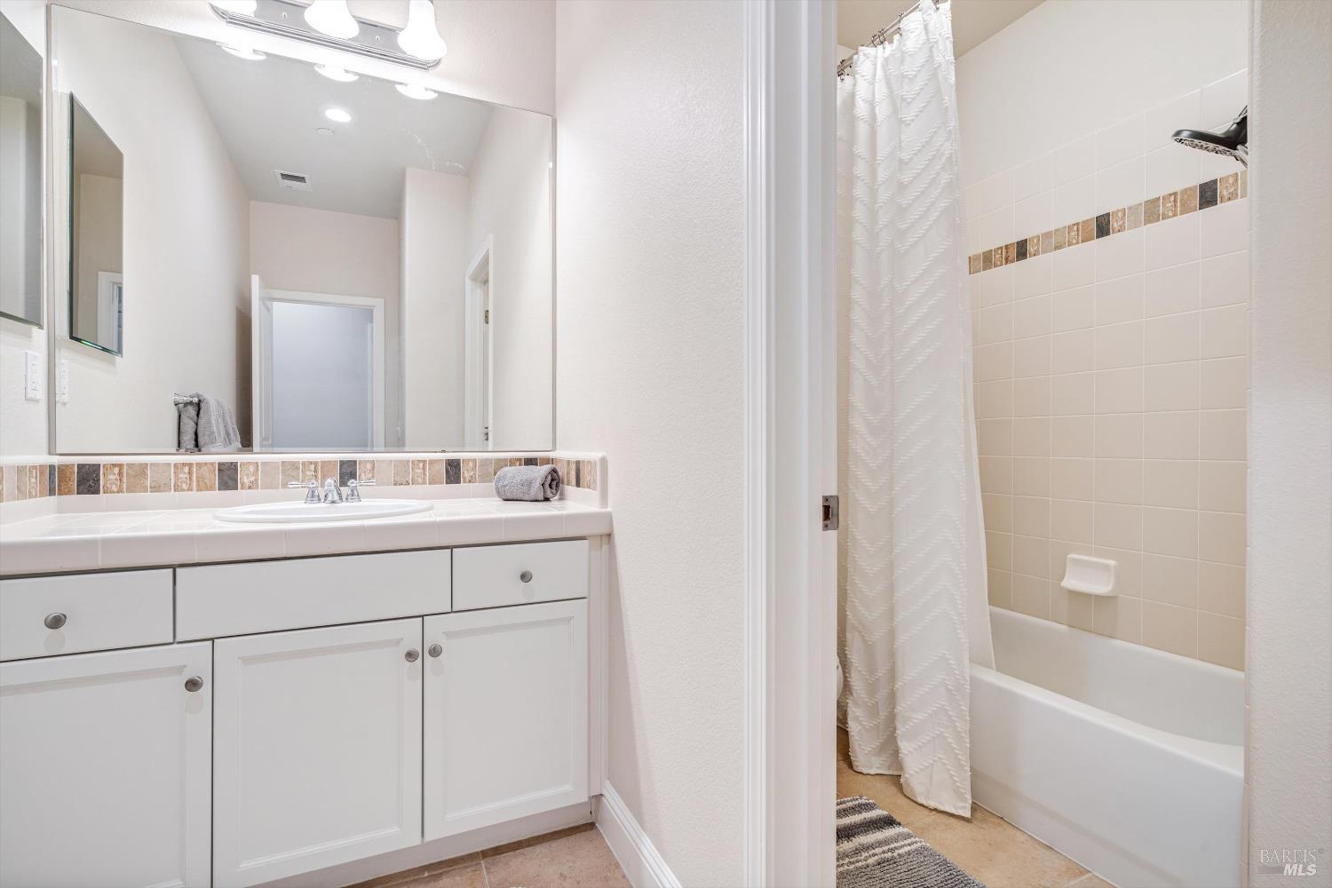 2084 Cooper Drive Santa Rosa, CA 95404 - Photo 17 of 37 Hall shared bath vanity separate from a shower over bath tub and toilet.