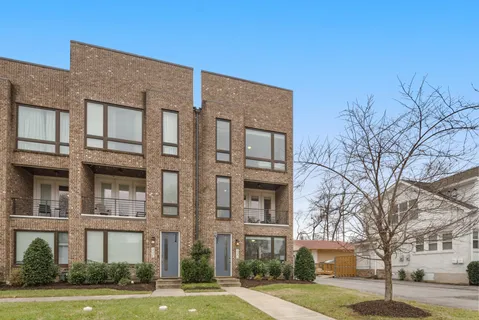 a front view of a building with a garden