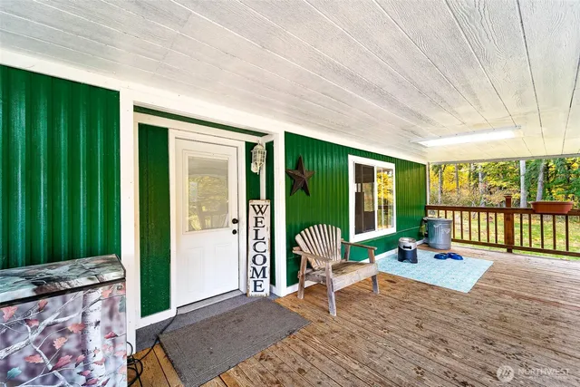 a porch with a table and chairs