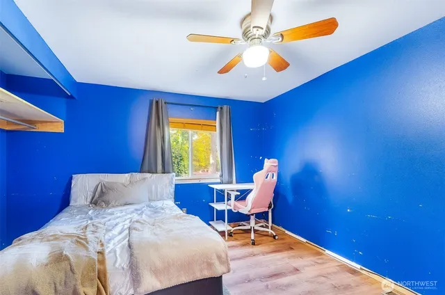 a bedroom with a bed and a chandelier