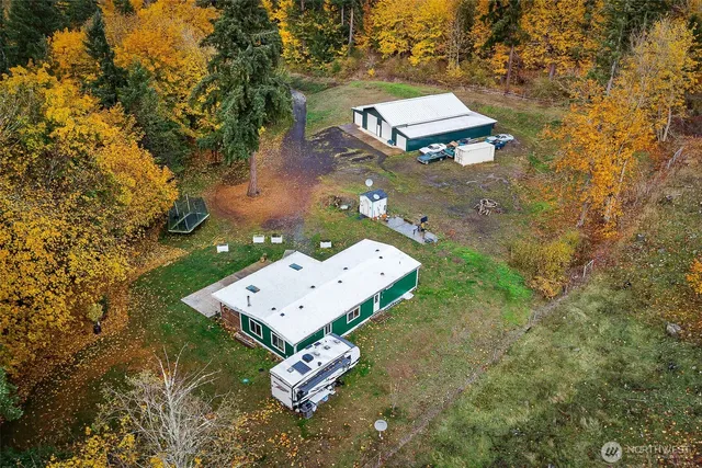 an aerial view of a house with a yard