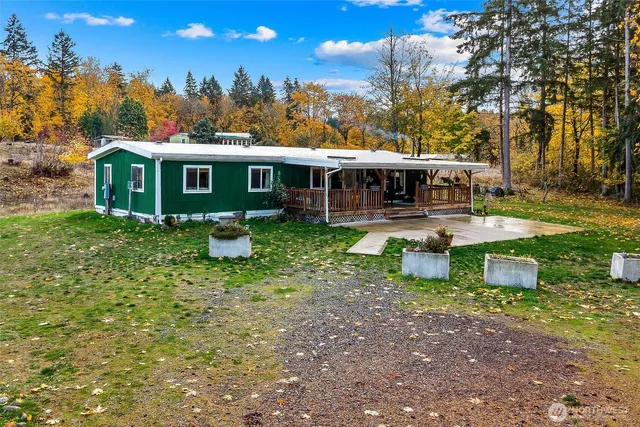 a view of a house with backyard porch and sitting area